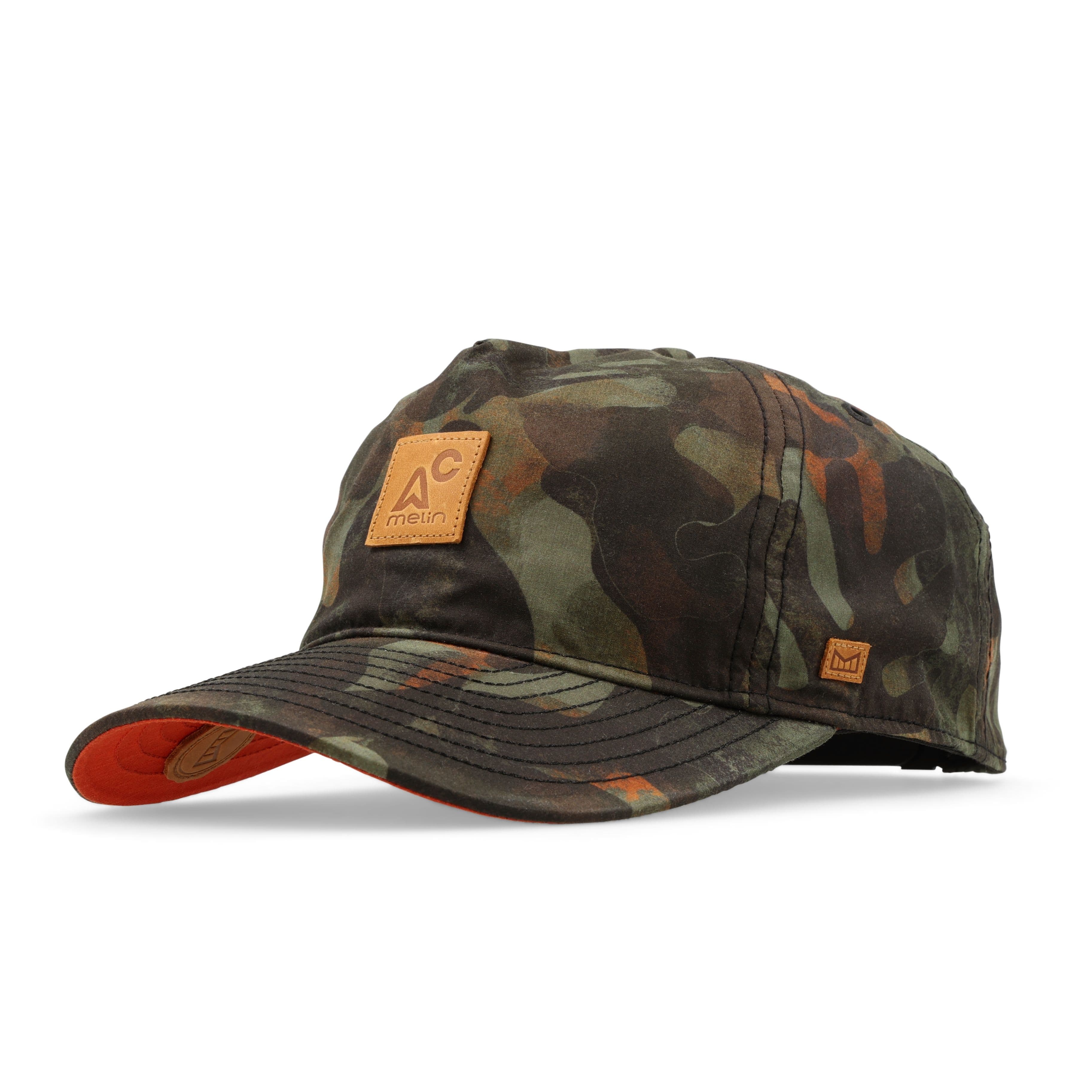 Melin Odysea MAC Nomad Thermal hat in Kelp Camo, three-quarter angled view showing the leather logo patch and curved bill